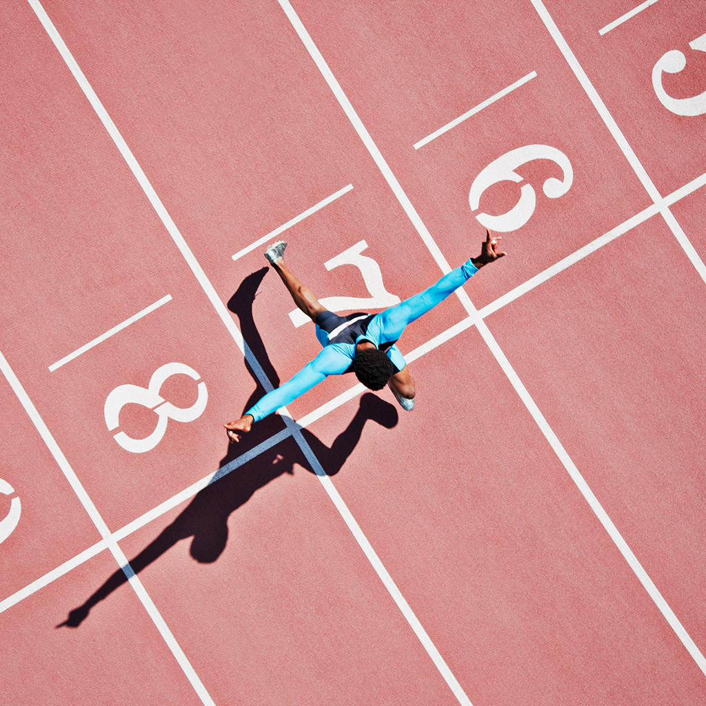 person on a running track crossing the finish line person on a running track crossing the finish line