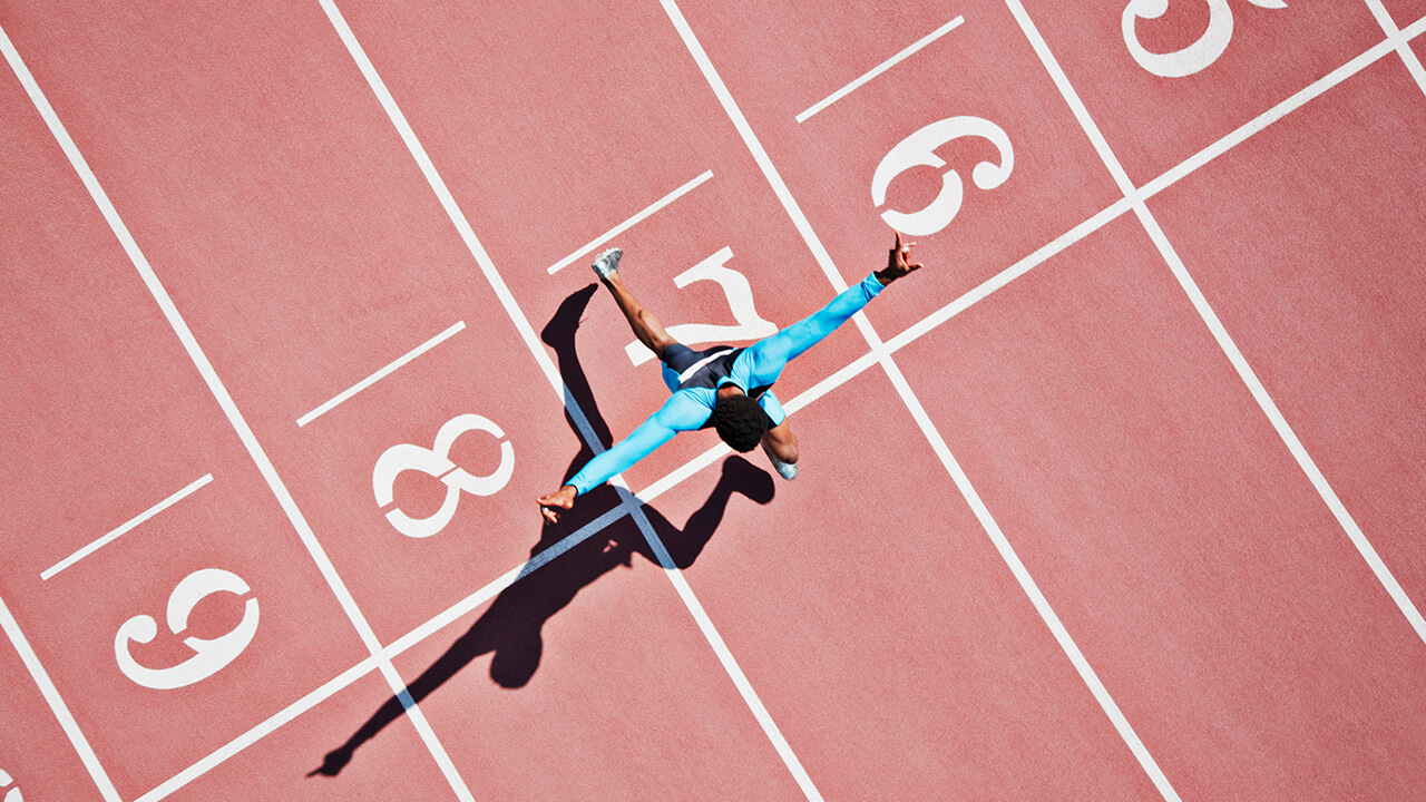  person on a running track crossing the finish line