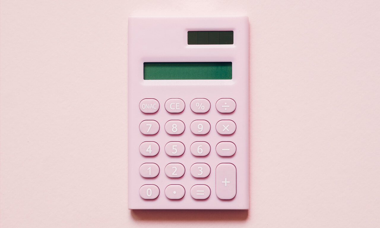 Pink calculator on pink background Pink calculator on pink background
