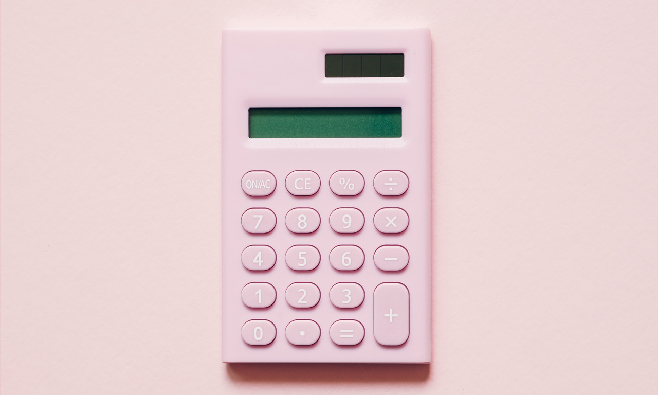 Pink calculator on pink background Pink calculator on pink background