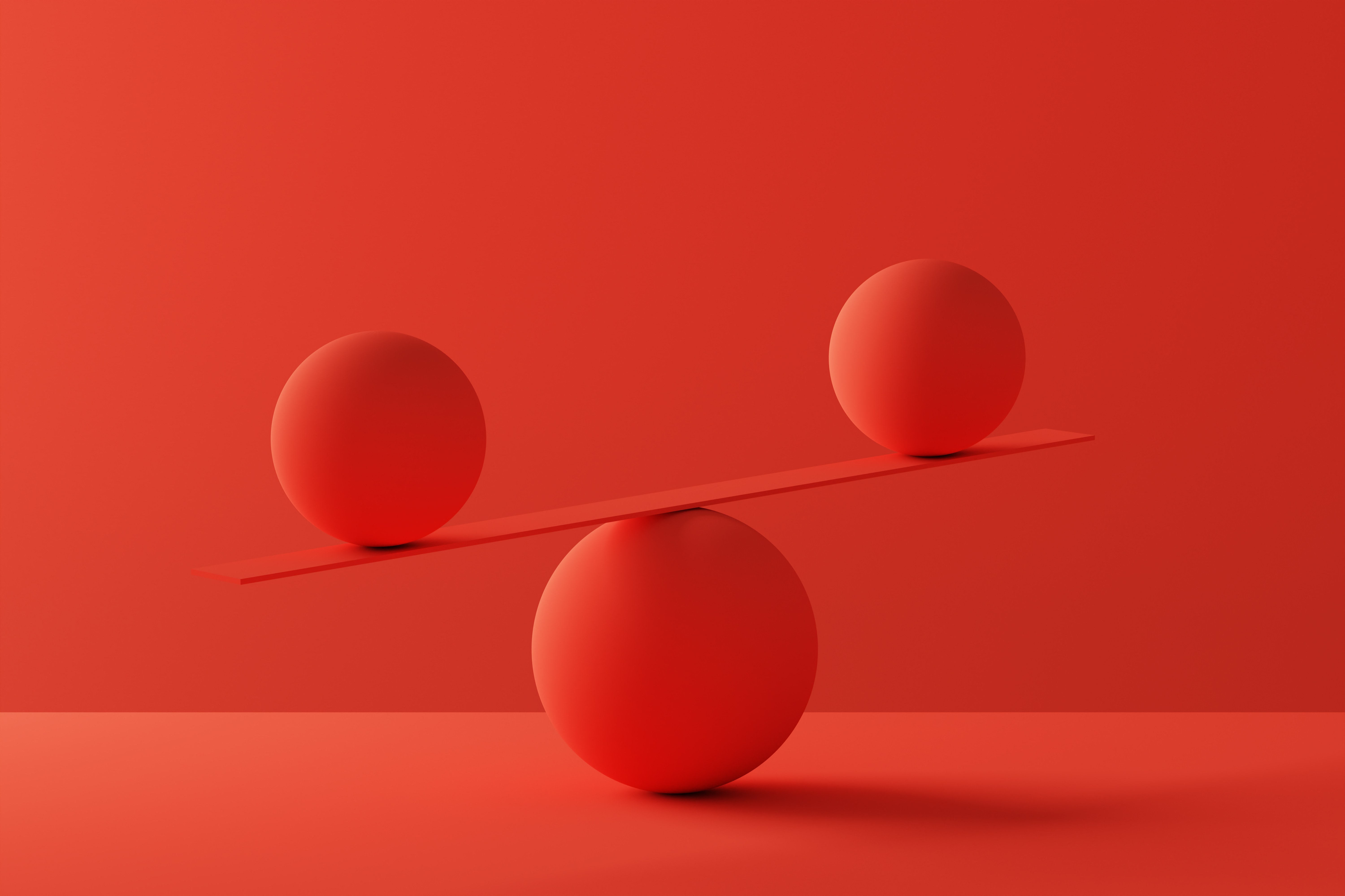 Two spheres in perfect balance over red background Two spheres in perfect balance over red background