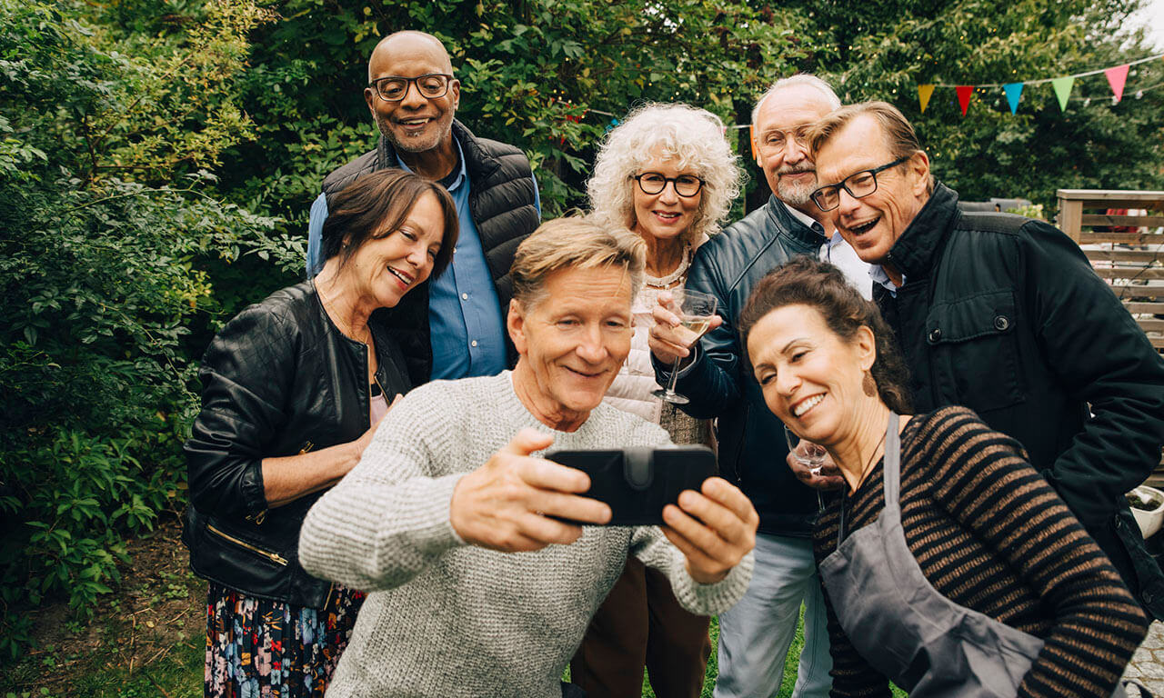 Happy group of older people posing together for a selfie