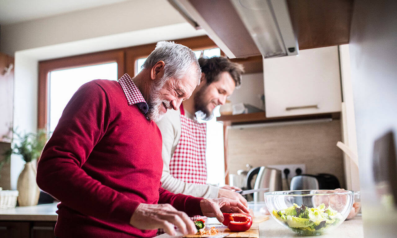 Happy father and son cooking together in a kitchen