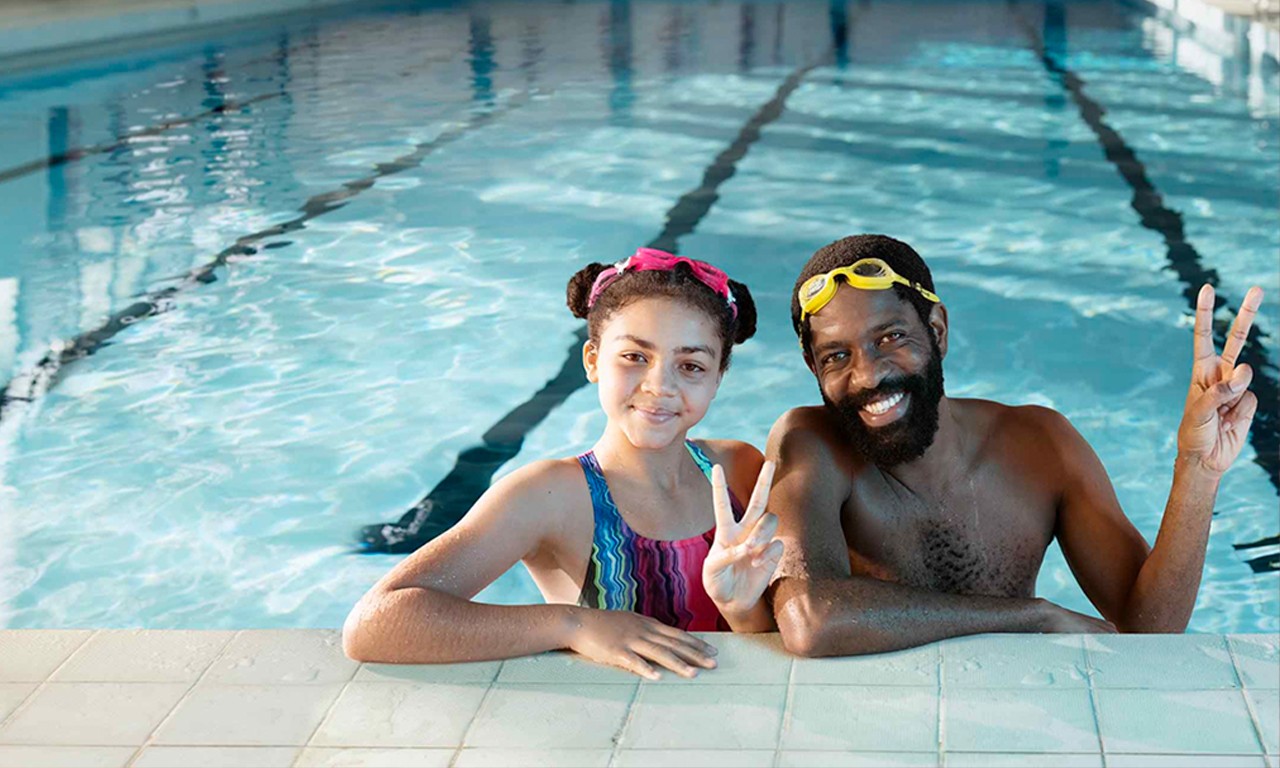 Father and daughter in swimming pool